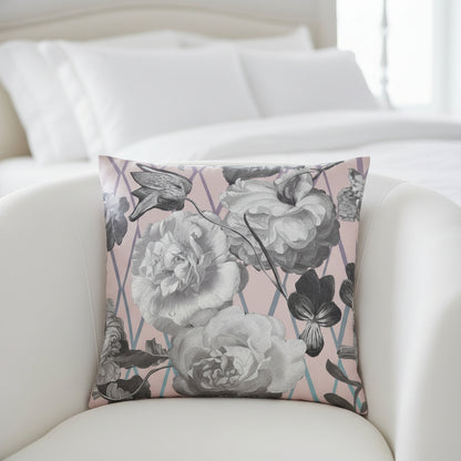 Floral patterned cushion with grey and white flowers on a pink background
