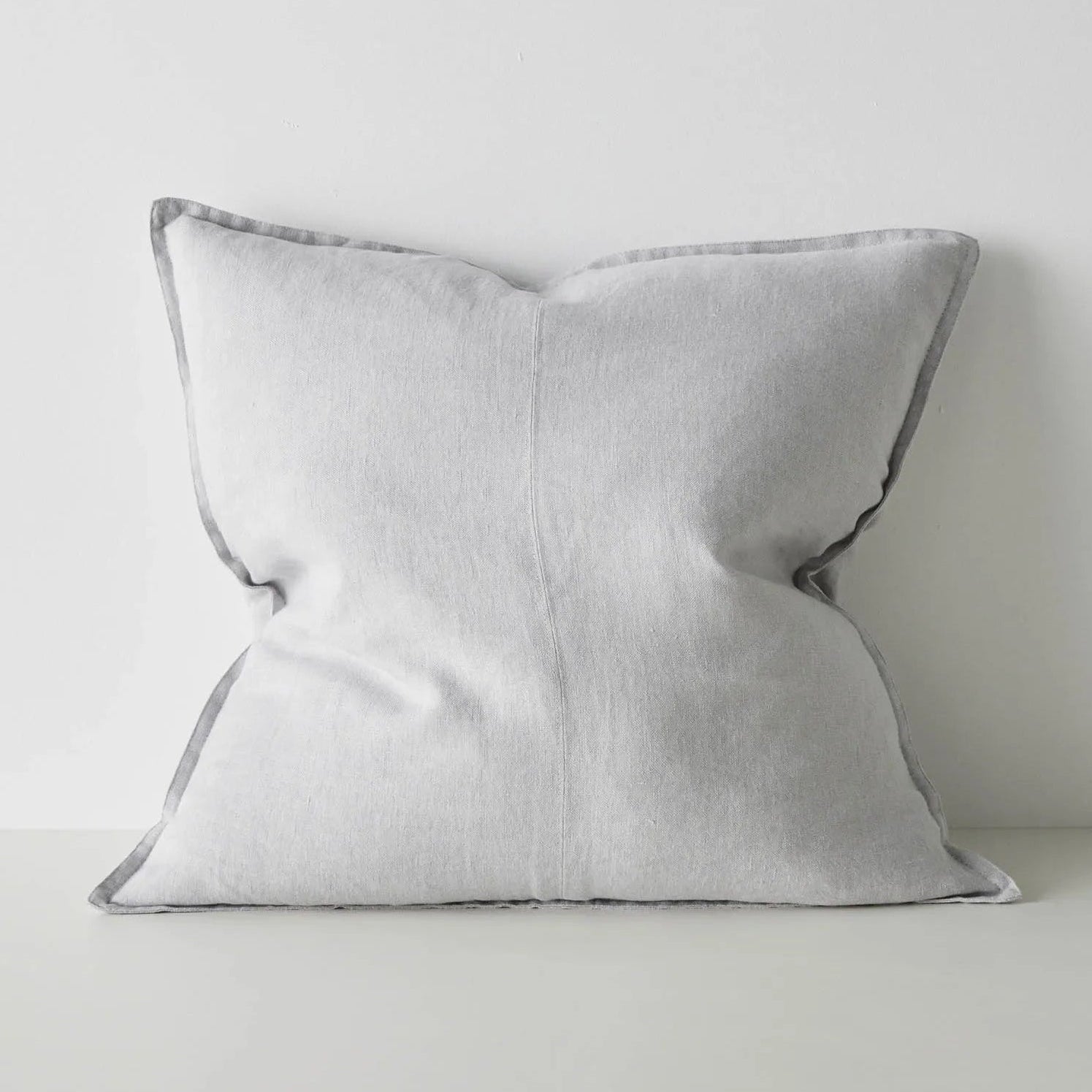 Light grey cushion on a light grey background