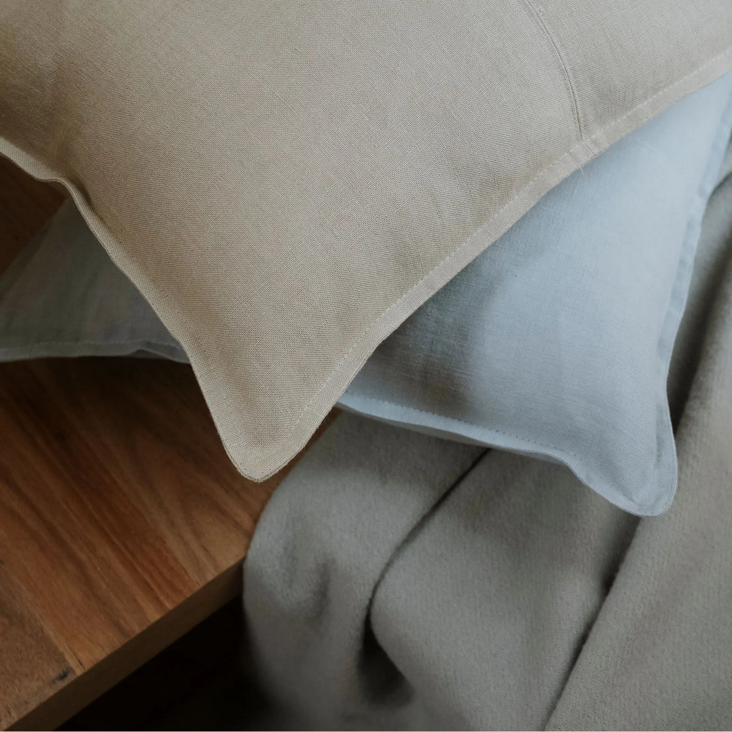 Close-up of a grey pillow on a wooden surface