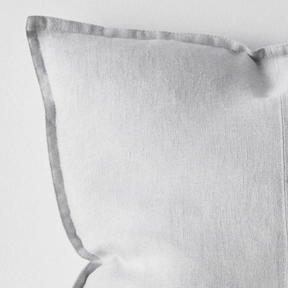 Light grey cushion with a subtle pattern on a light grey background