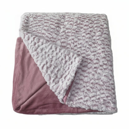 Two-toned luxurious faux fur throw blanket with textured blush pink side and solid blush pink reverse on a white background